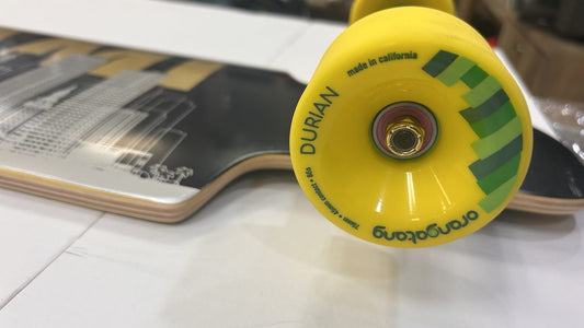 Yellow Orangatang Durian wheel close-up on High Five Miami complete