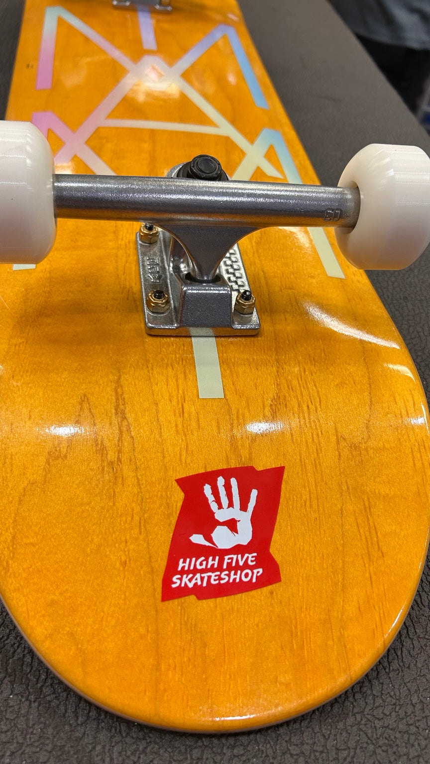 High Five orange complete skateboard – H truck close-up